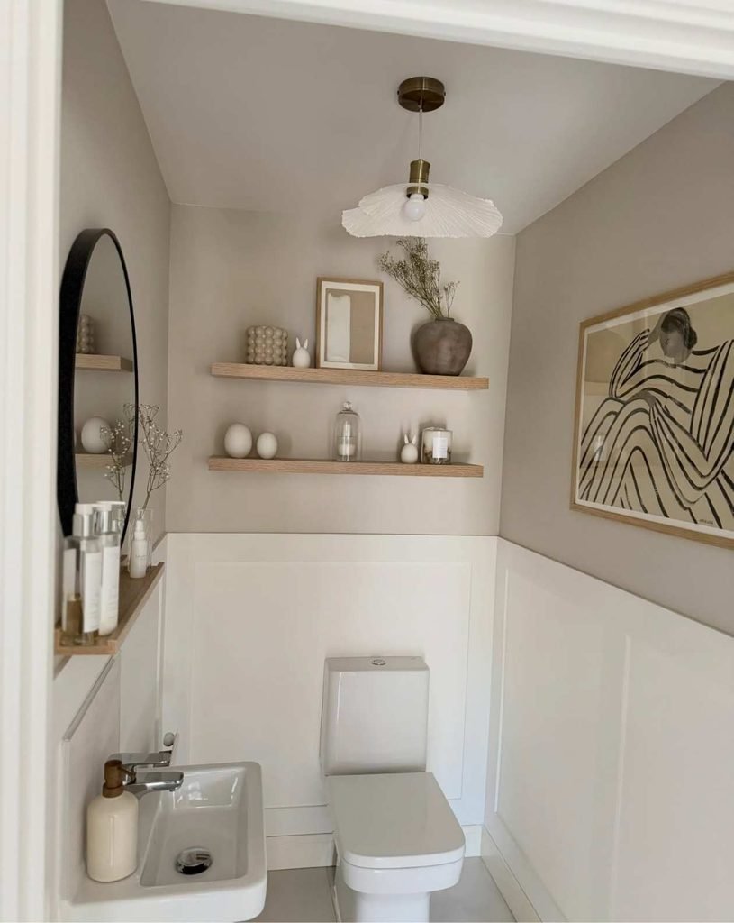 Floating shelves are one of the best ways to add storage and personality to a small toilet room without taking up valuable floor space. This design uses simple wooden shelves above the toilet to create an organized yet stylish display area.