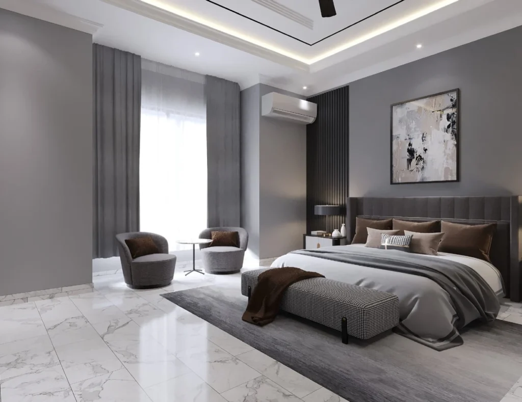 Grey bedroom with brown cushions, houndstooth bench and two round chairs by a tall window