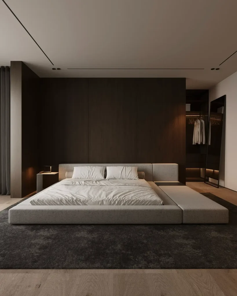 Oatmeal platform bed on a charcoal rug in front of a dark walnut panel wall