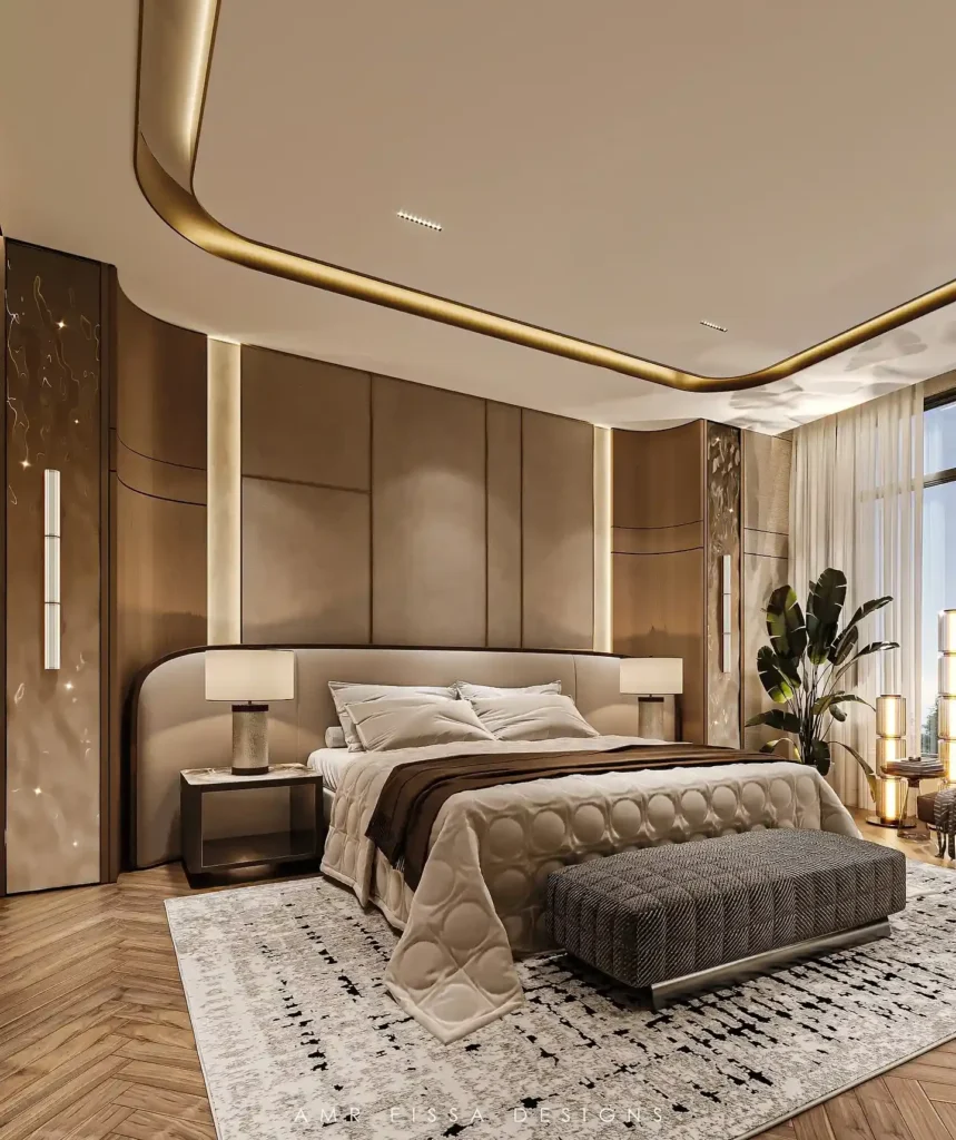 Sand-colored bed with curved brass ceiling trim, woven bench and herringbone wood floor